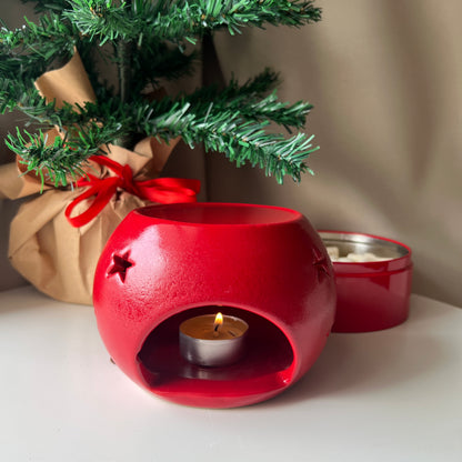 Handcrafted Christmas ornament-shaped wax melter with a festive red and white design, featuring a tealight holder and a wax melt tray, perfect for creating a cozy holiday ambiance.